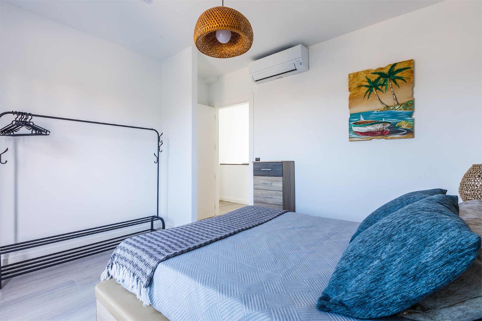 Dormitorio con cama doble, aire acondicionado y burro para la ropa
